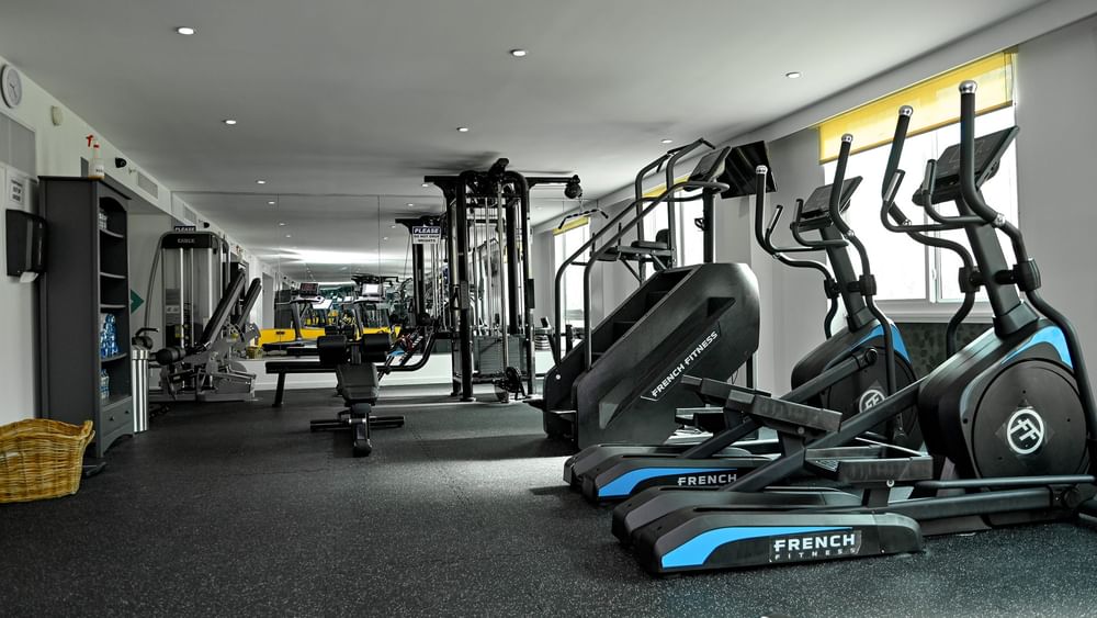 Multiple exercise machines including treadmills and weight machines in gym at Warwick Paradise Island - Bahamas, Nassau.