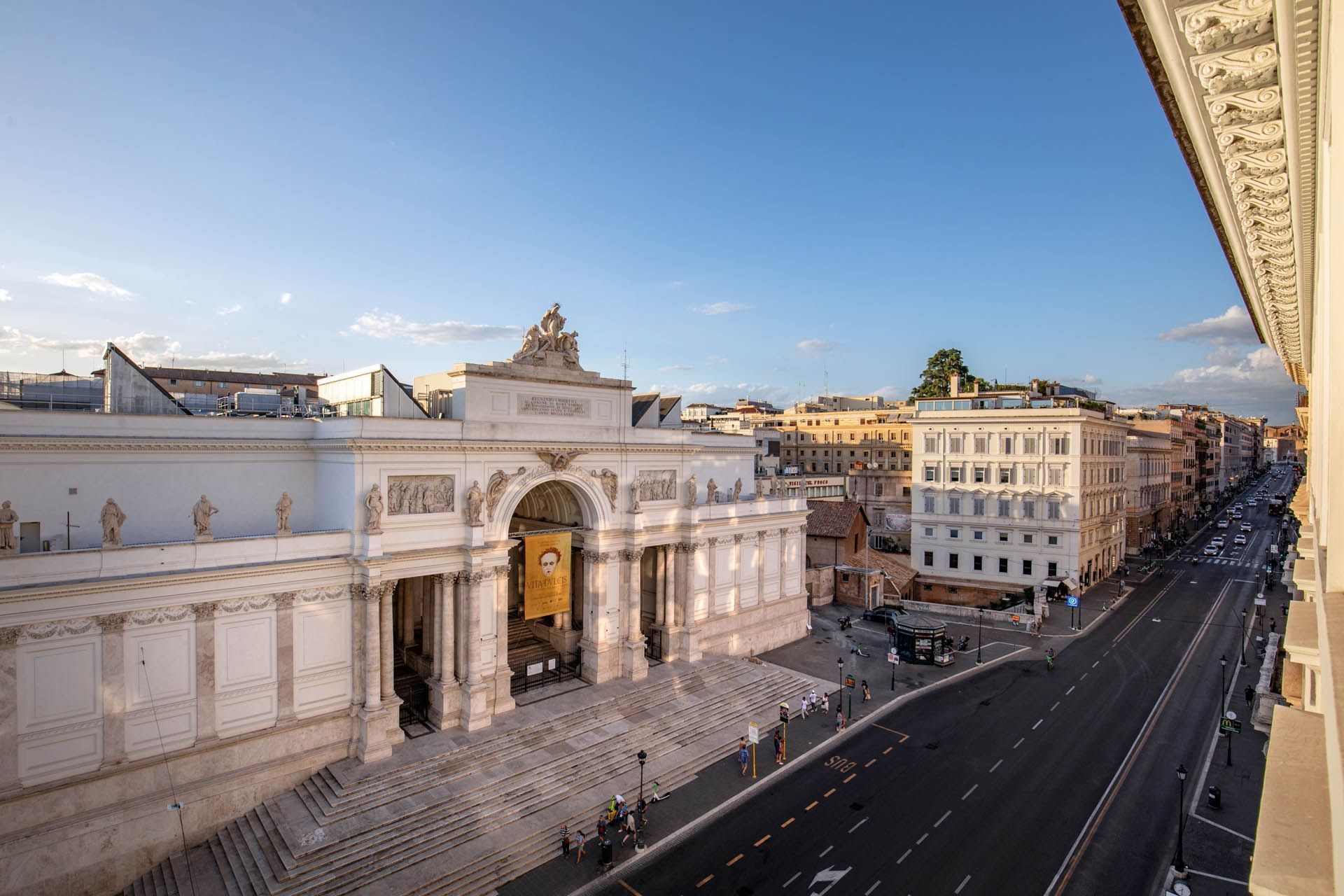 Palazzo delle Esposizioni surrounded by urban buildings and a wide street near The Glam Hotel