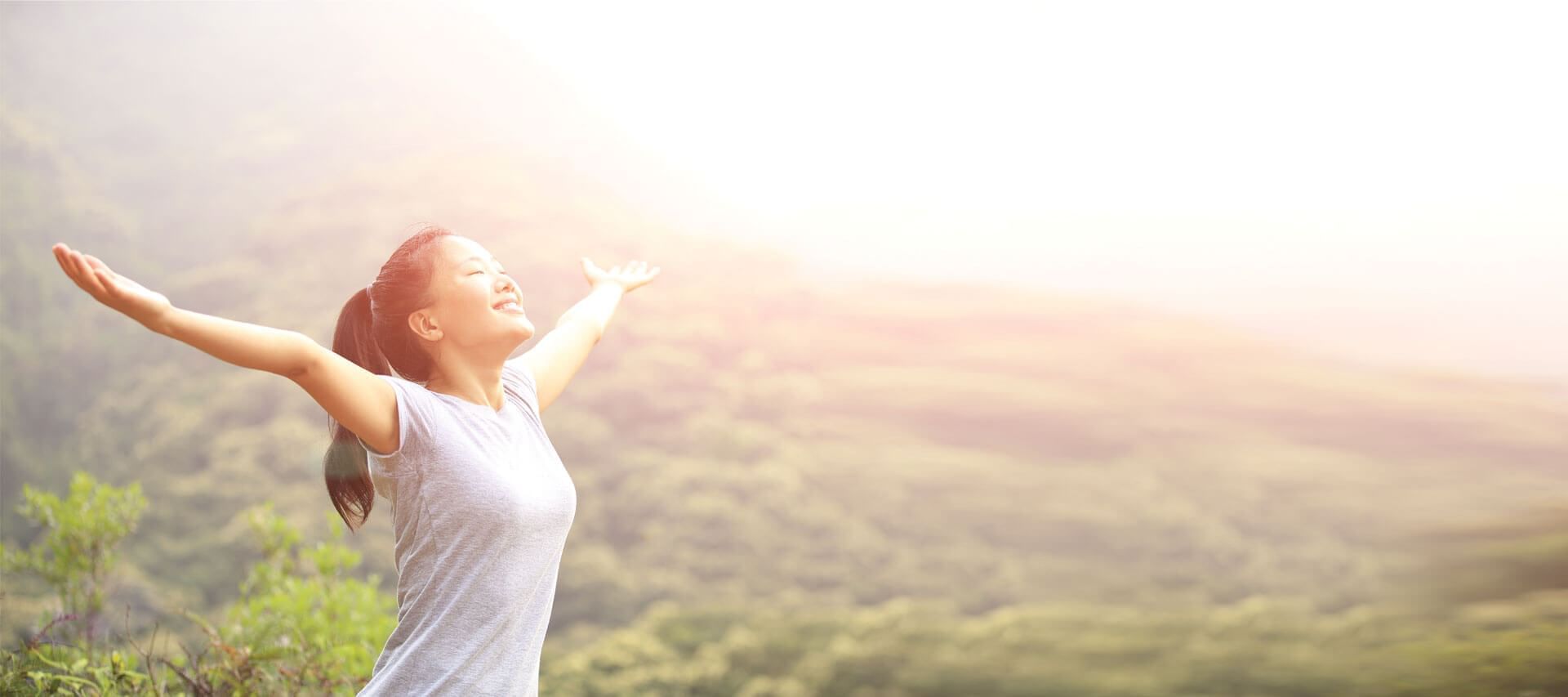 A girl enjoying the sunrise with open arms at Sunway Lagoon