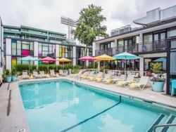 Outdoor pool area with sun loungers at The Verb Hotel