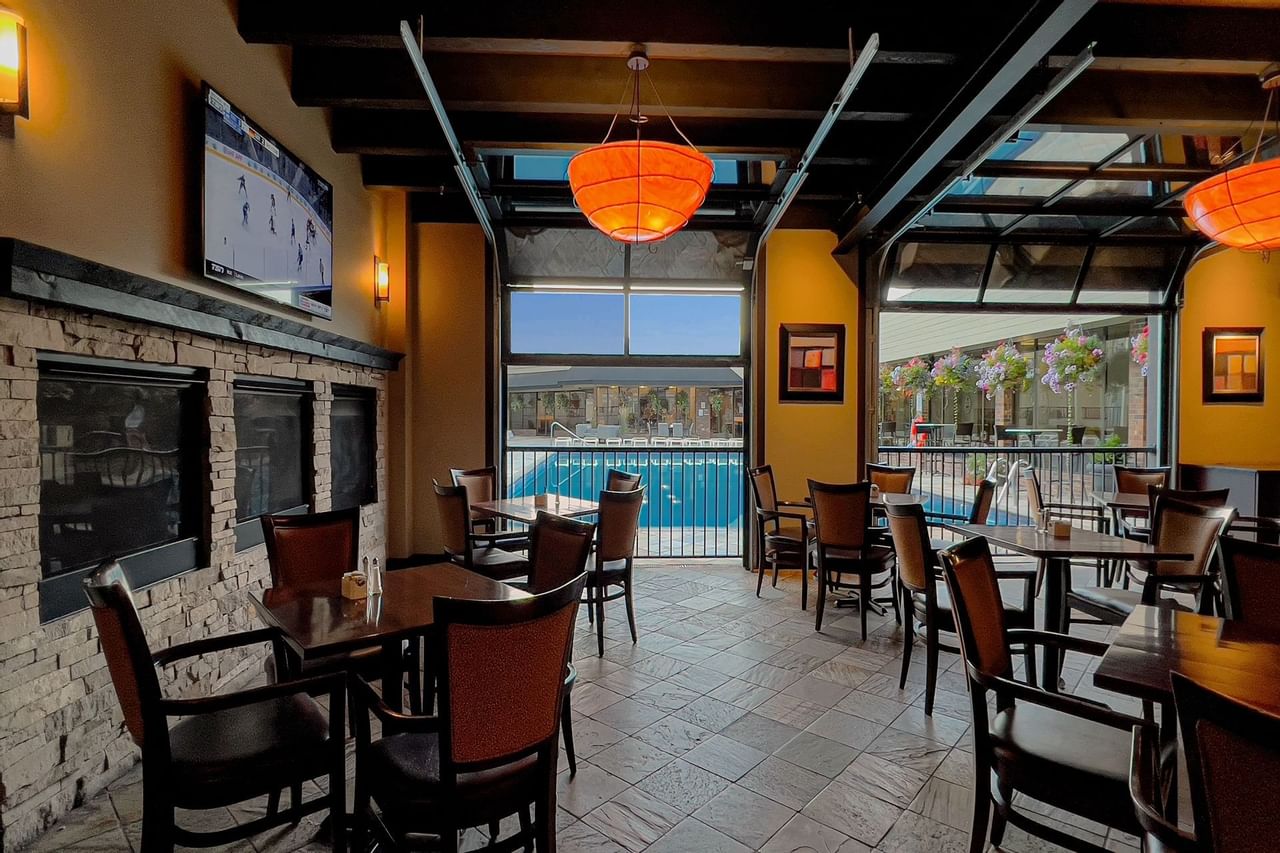 Indoor restaurant with patio doors open to pool