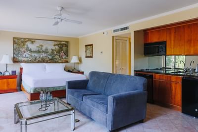 Bed & lounge area in Studios at Dinah's Garden Hotel