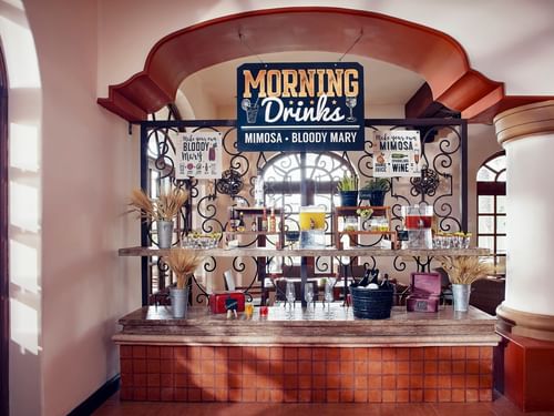 Self-serve Bloody Mary and Mimosa bar with various juices and garnishes in Trattoria Pomodoro at Hacienda del Mar Los Cabos.