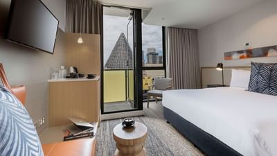 TV & king bed in studio room at Brady Hotels Central Melbourne