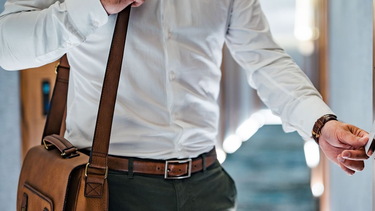 man tapping hotel key card on door
