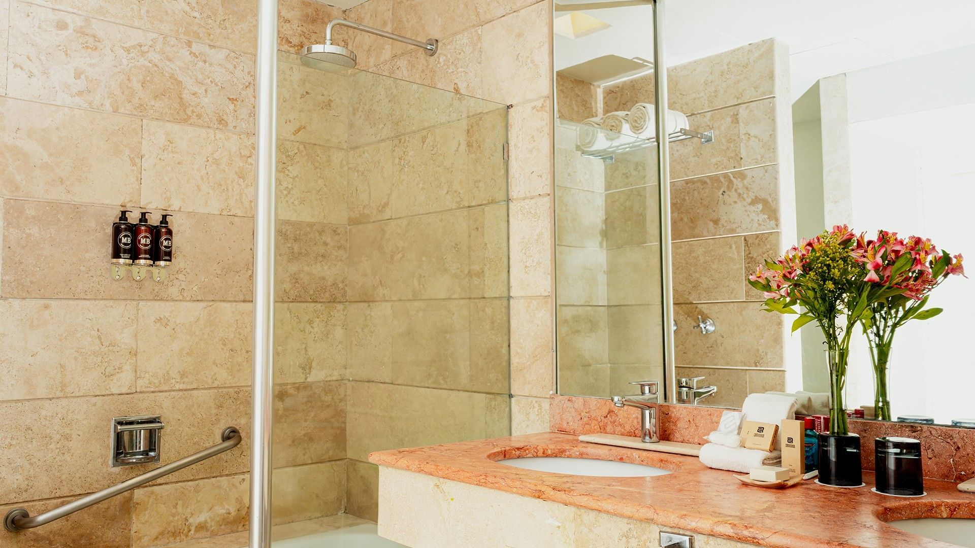Bathroom vanity with a mirror, amenities, and a shower area in Two Double Camino Real Club at Camino Real Zaashila Huatulco