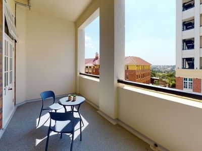 Single Room Balcony with chairs and table at UniLodge Herston.