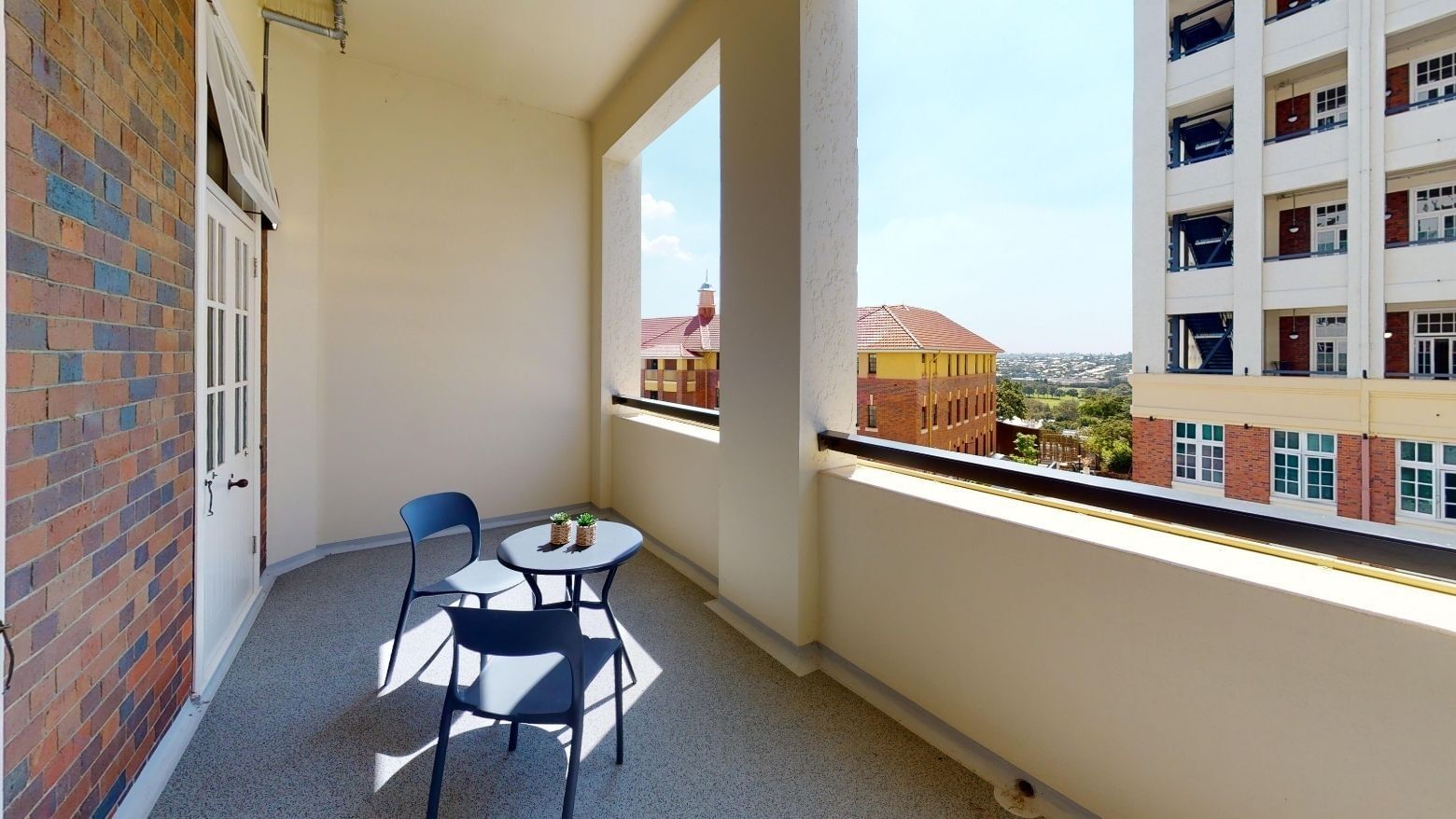Single Room Balcony with chairs and table at UniLodge Herston.