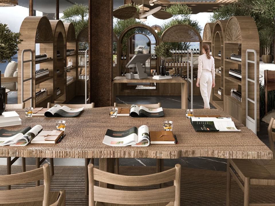 Relaxing wellness lounge and shop with a thatched roof and natural decor in The LifeCo Wellness Center at A'ila Resorts