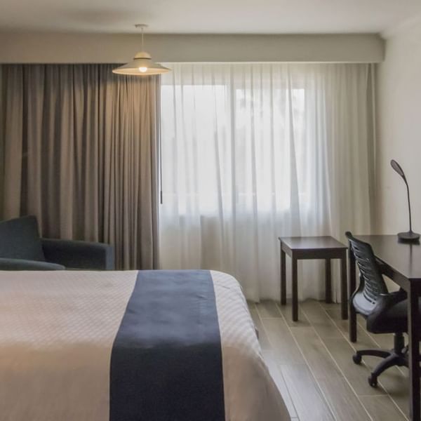 Bed, sofa & desk in the Superior King Room at Gamma Hotels