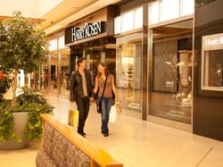 A couple shopping at the CF Chinook Centre near Carriage House Hotel