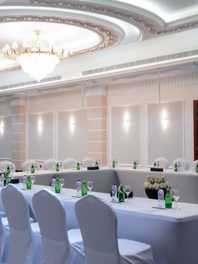 Elegant Orchid 1 event room setup with tables and chairs at Warwick Hotel & Spa Jeddah.