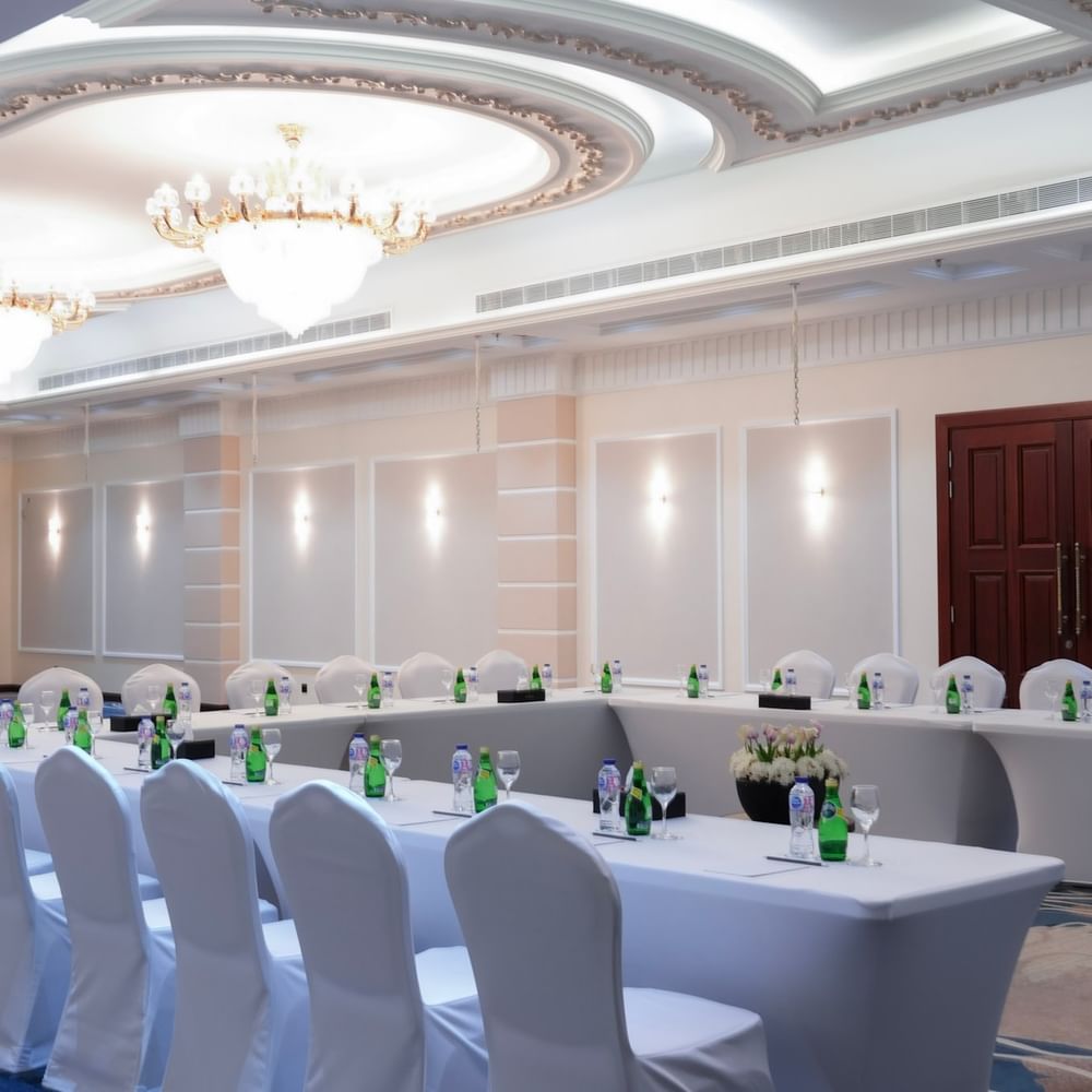 Elegant Orchid 1 event room setup with tables and chairs at Warwick Hotel & Spa Jeddah.