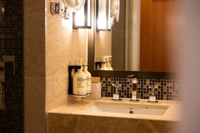 A close-up of a elegant marble bathroom and amenities at the Royal on the Park Hotel