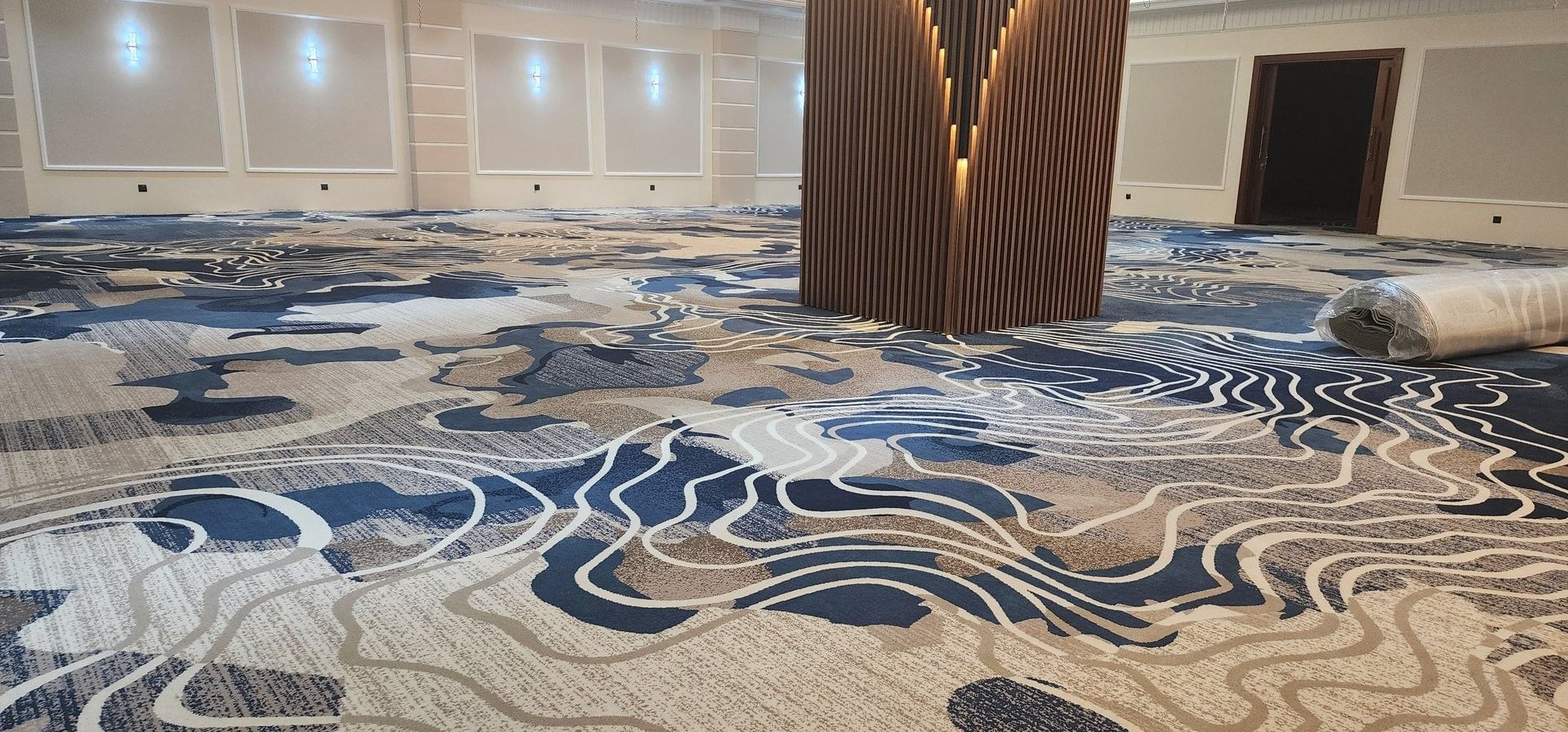 Spacious ballroom featuring a patterned blue carpet under stylish chandeliers at Warwick Jeddh Hotel & Spa