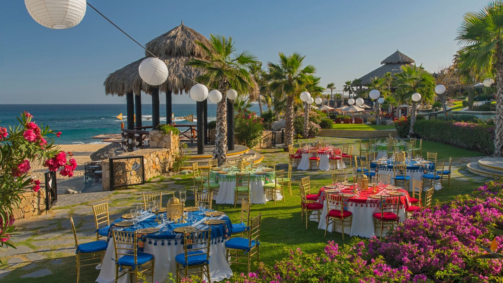 Palapa Fiesta Dinner Reception with colorful tables and chairs at Hacienda del Mar Los Cabos