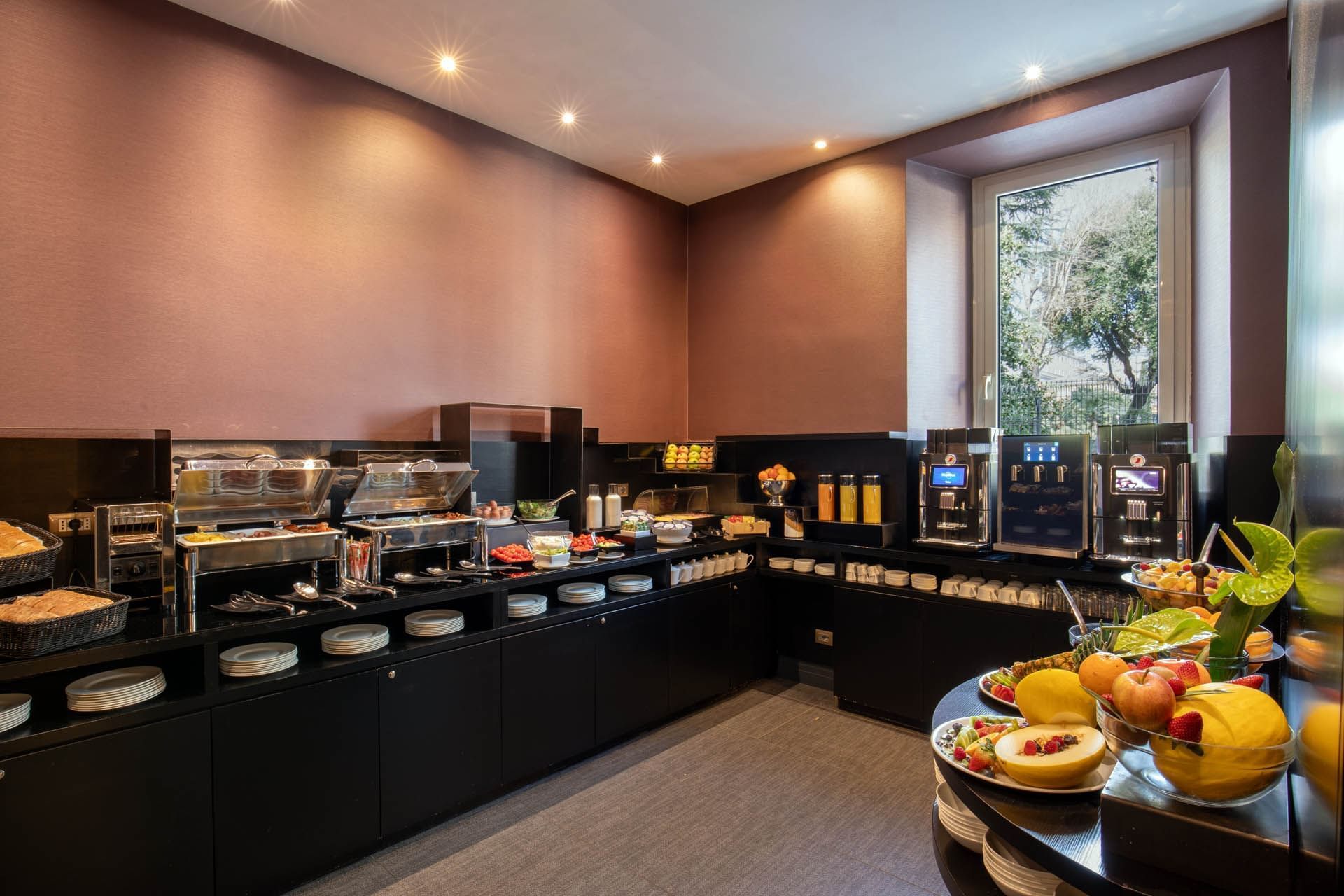 Modern Breakfast restaurant at The Guardian Hotel featuring fresh fruits, salads, beverage dispensers, and soft lighting