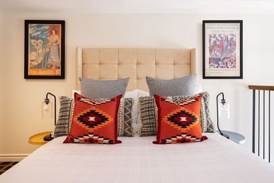 Cozy king bed, nightstands & wall pictures in Superior Loft at Retro Suites Hotel
