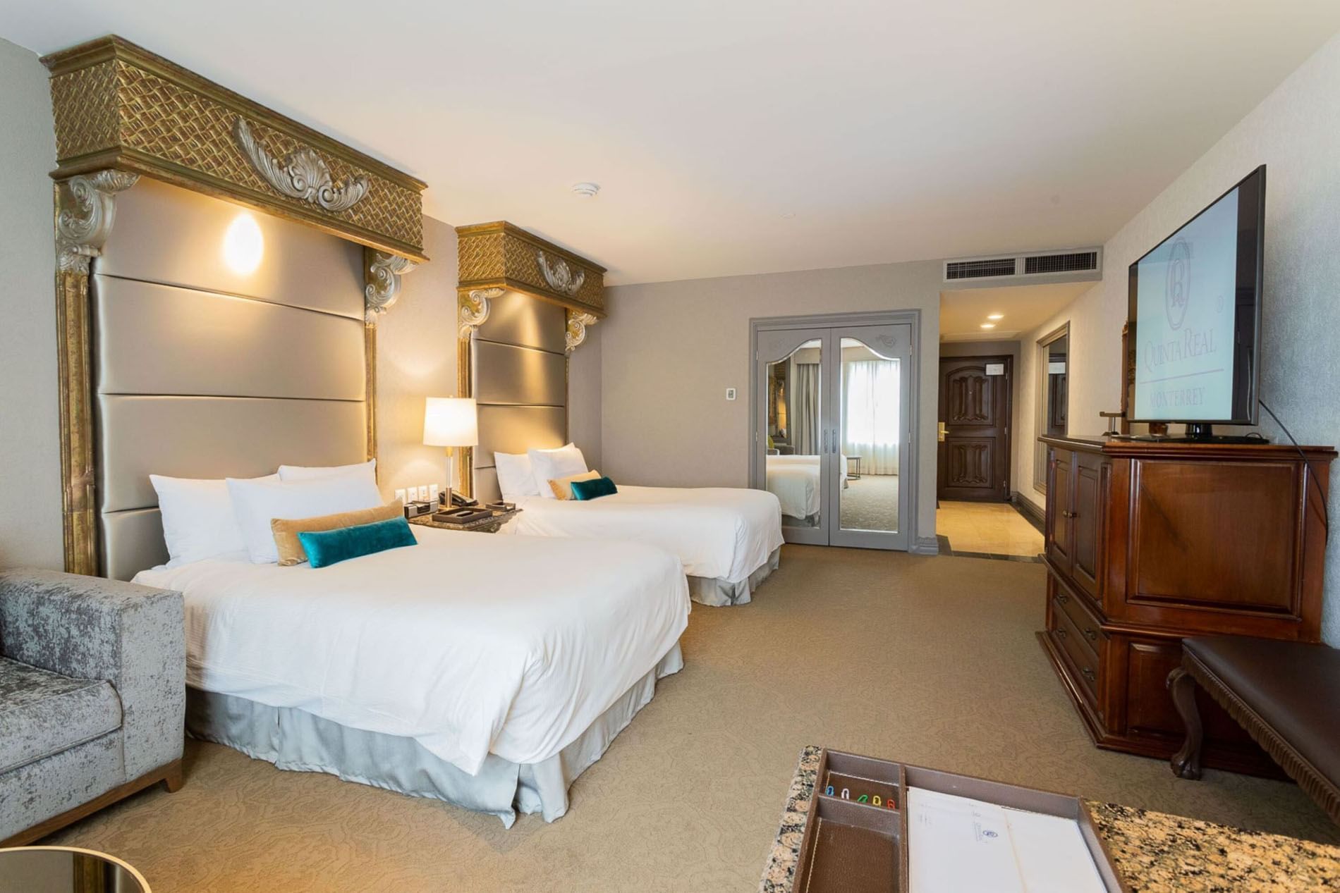 2 Double Executive Tower with two queen beds, ornate headboards, and a large wooden armoire at Quinta Real Monterrey