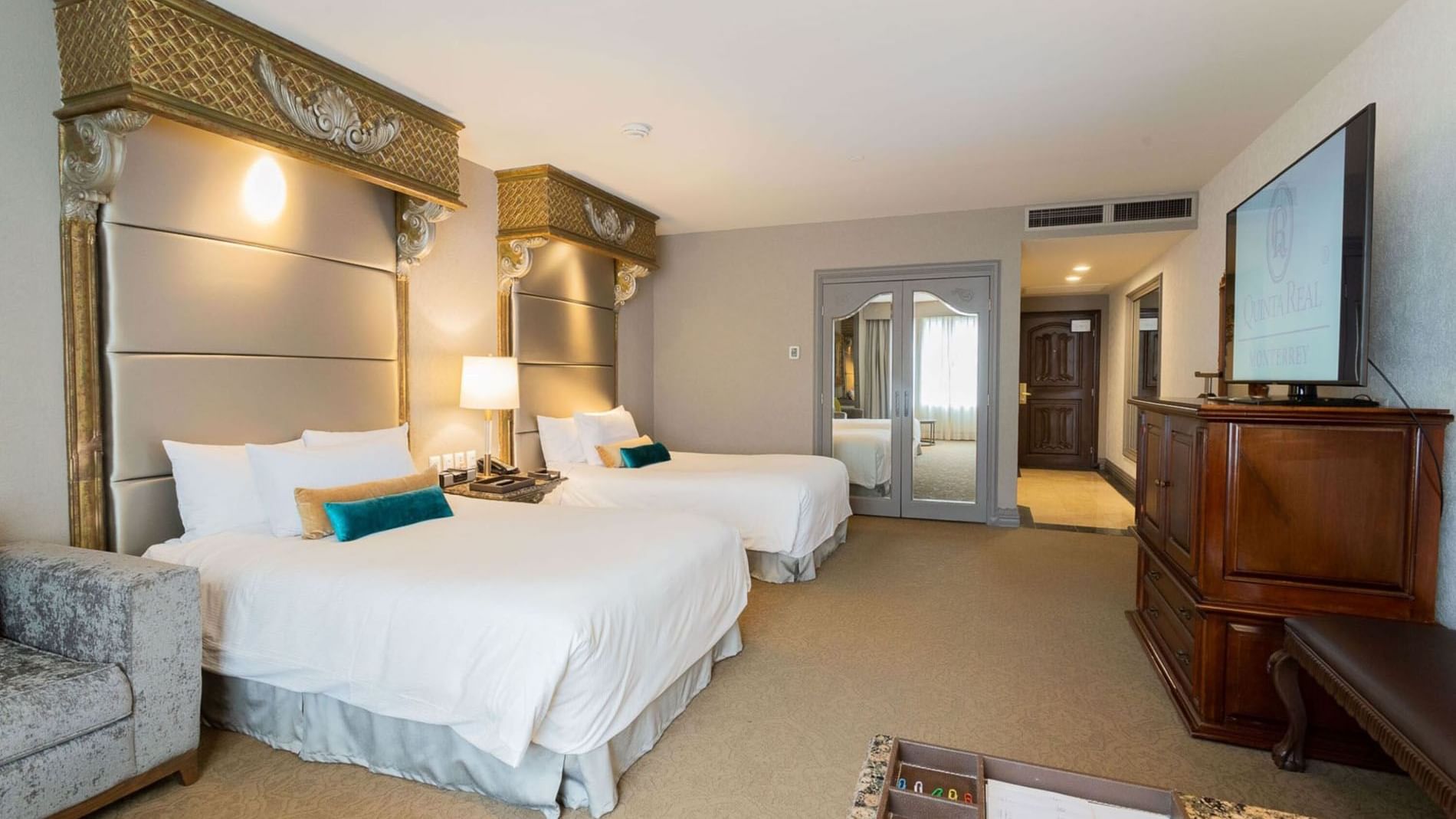 2 Double Executive Tower featuring ornate gold headboards and plush white bedding at Quinta Real Monterrey