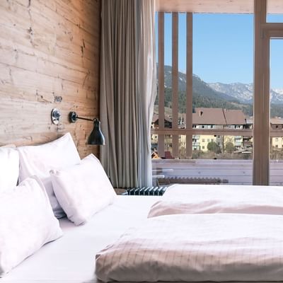 Bed & mountain view in Junior Suite at Falkensteiner Hotels