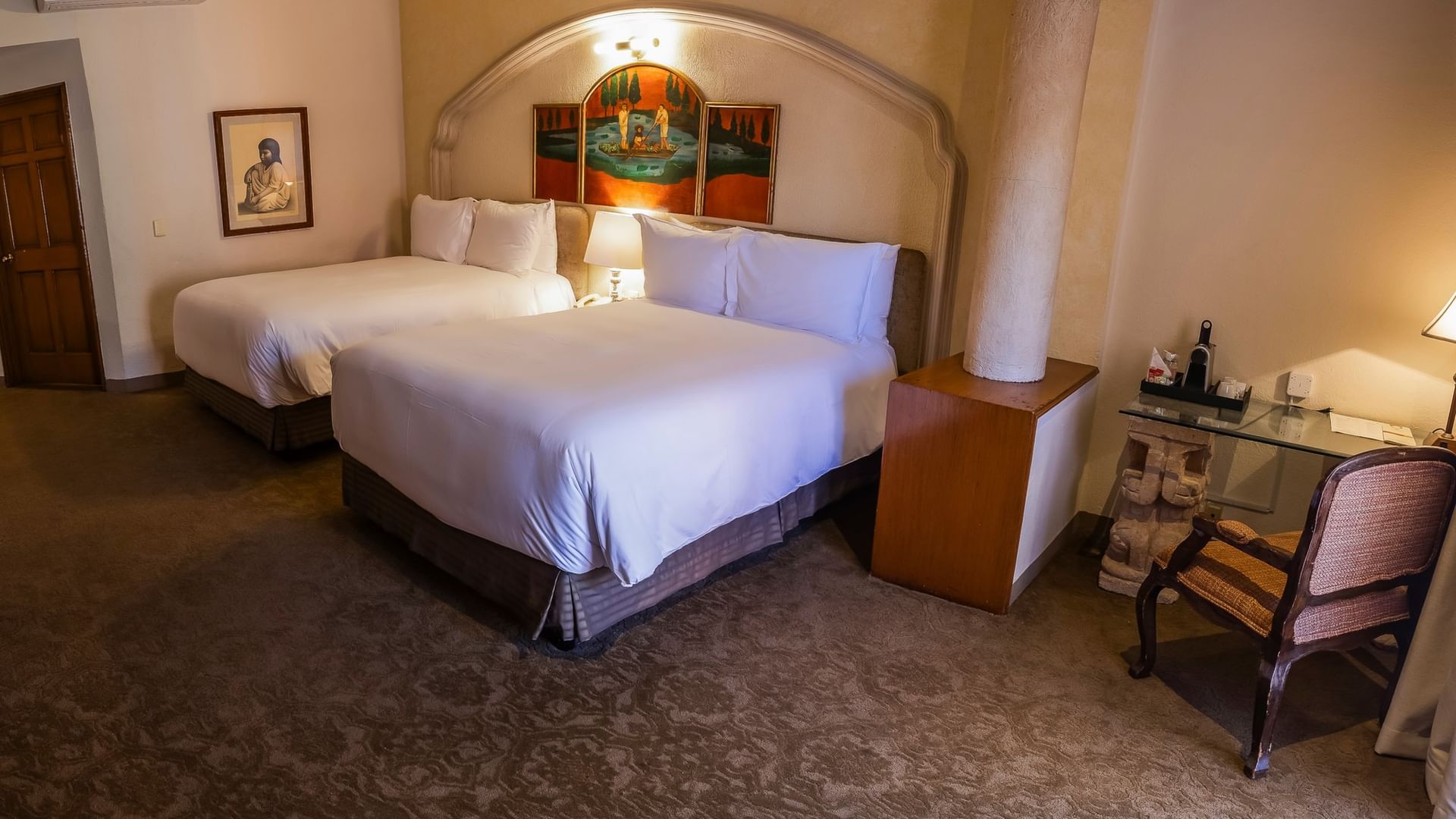 Habitación espaciosa con dos camas dobles, arco colonial y decoración tradicional en Quinta Real Zacatecas