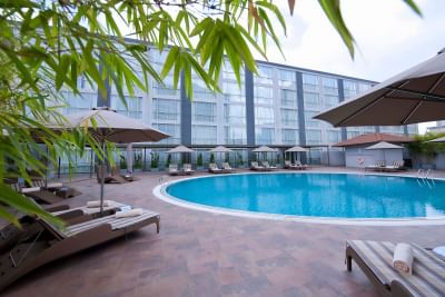 Outdoor swimming pool with pool beds at Eastin Grand Hotel Saigon