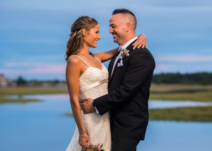 A wedding couple looking at each other with smiling faces at Ogunquit Collection