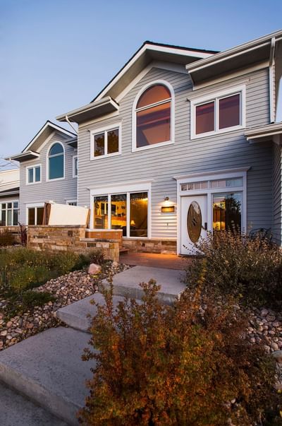 Residences at The Stanley Hotel with a front walkway, wooden structure and warm lights in the windows