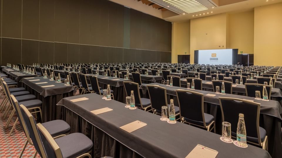 Grand conference hall with rows of seating and a projector screen at Camino Real Polanco Mexico