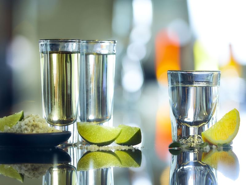 Glasses of tequila & lime slices in J Folklore at Gamma Hotels