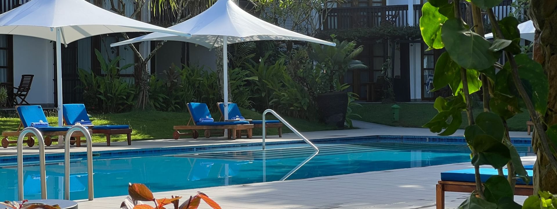 Blue loungers by adult-only pool and bar at Warwick Fiji Resort and Spa in Korolevu