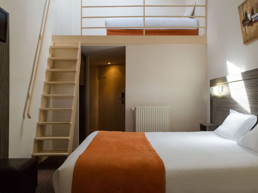 A bedroom with a staircase at Hotel L'Acropole