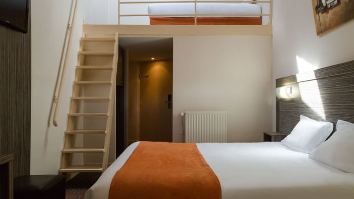 A bedroom with a staircase at Hotel L'Acropole