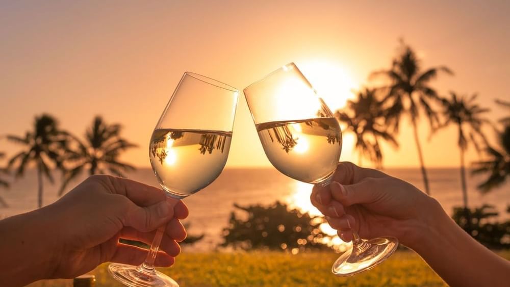 Couple toasting wine at sunset in Grand Fiesta Americana