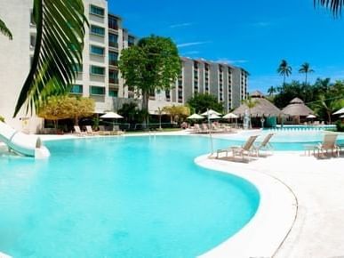 Exterior view of Gamma Hotels with outdoor pool