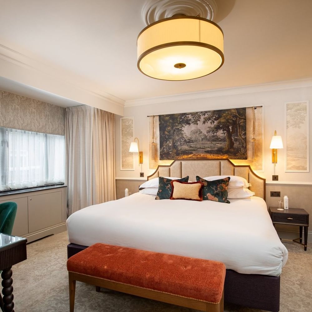 Elegant suite with a large bed and modern decor at The Capital Hotel, Apartments & Townhouse
