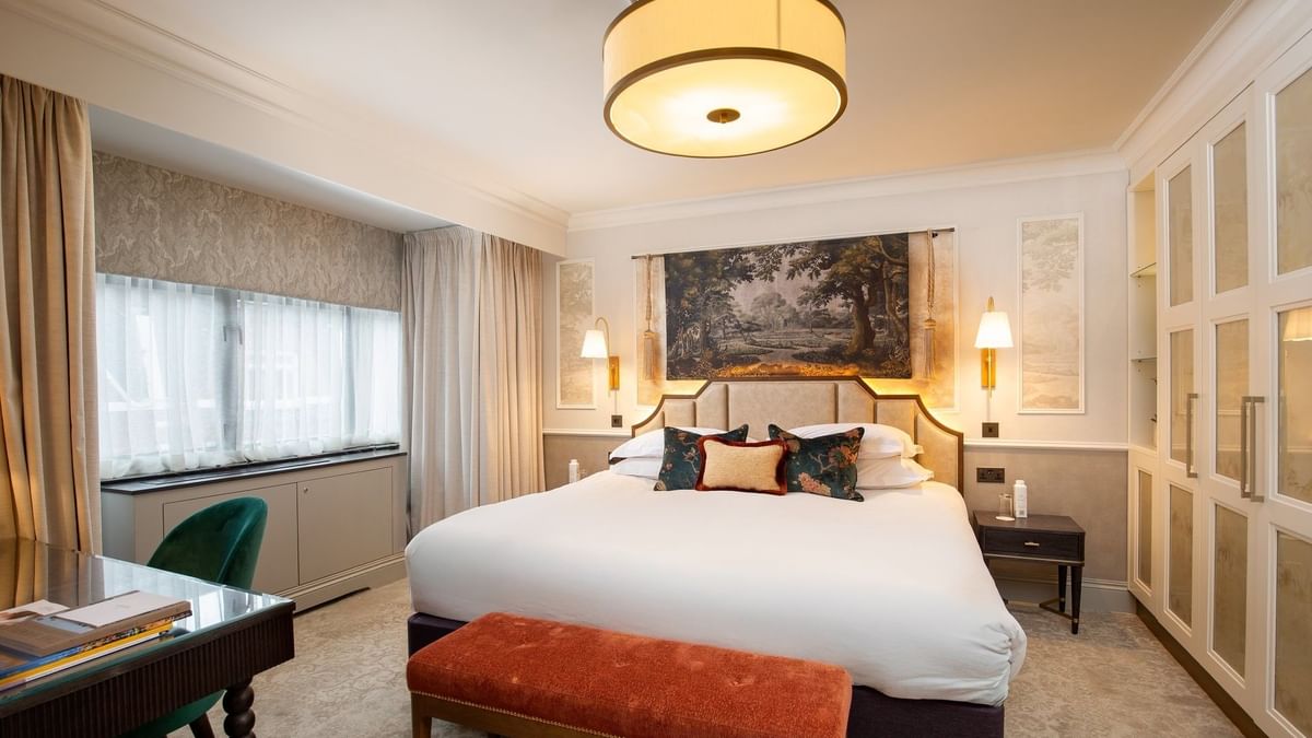 Elegant suite with a large bed and modern decor at The Capital Hotel, Apartments & Townhouse