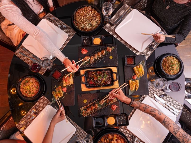 Guests enjoying a meal at Golden Buddha restaurant at Pickalbatros Laguna Vista Hotel in South Sinai Governorate.