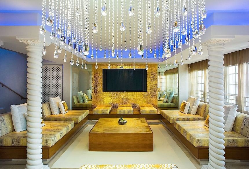 Chandelier light with sofa at sun house at Dream South Beach