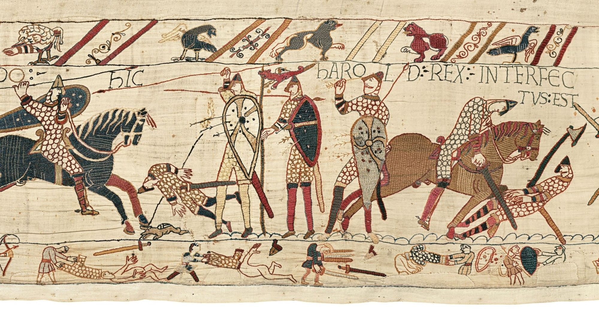 Bayeux Tapestry depicting armored knights on horseback with shields and weapons in battle scene. Shown at British Museum