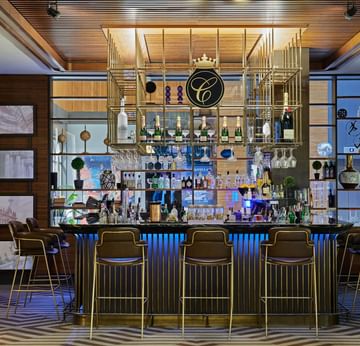 Interior of Lobby Bar 'Charlotte' with Bar counter area and stools at Titanic Chaussee Berlin