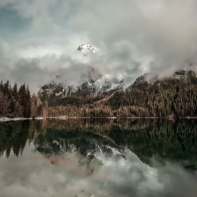 Misty mountains behind a lake near Falkensteiner Hotels