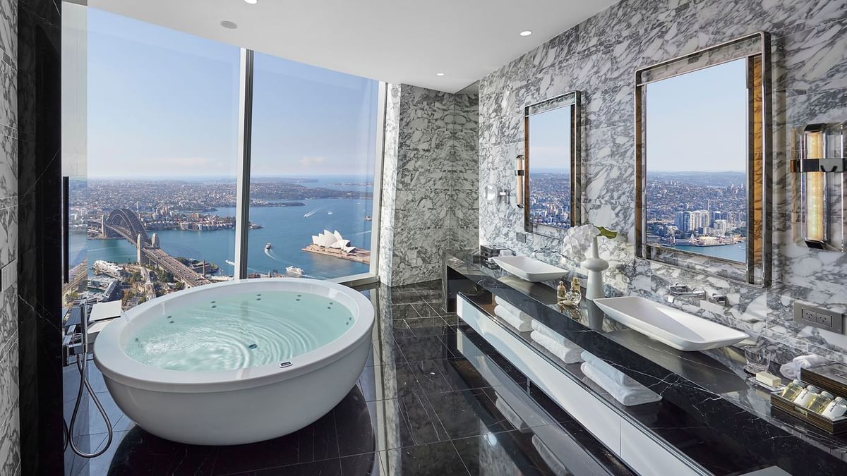 Luxury bathroom with large windows overlooking the Sydney City in Harbour Villa at Crown Hotels