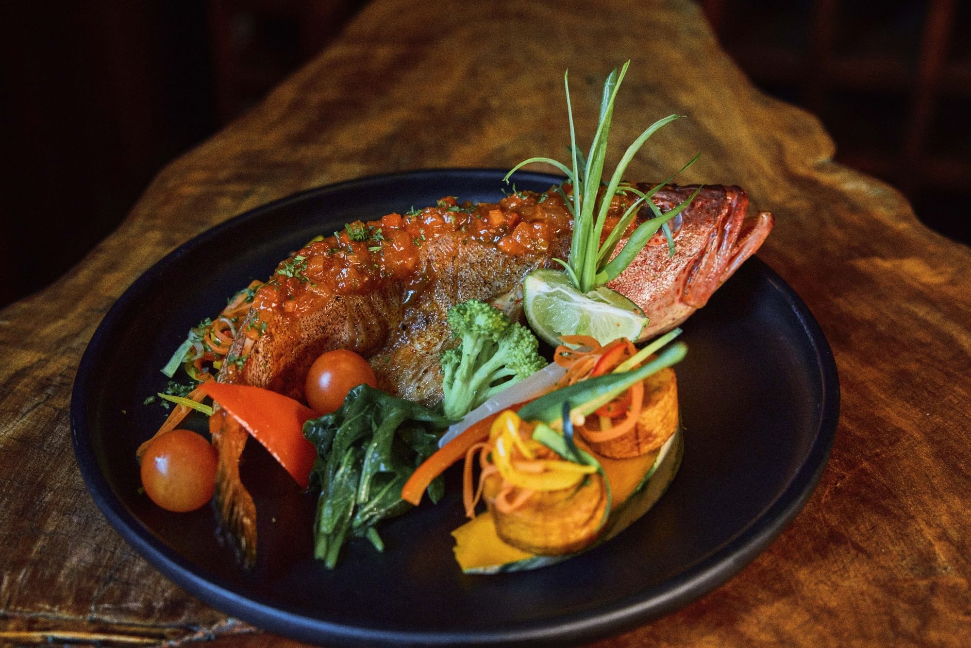 Fried fish dish served on a wooden table in Dasheene St Lucia