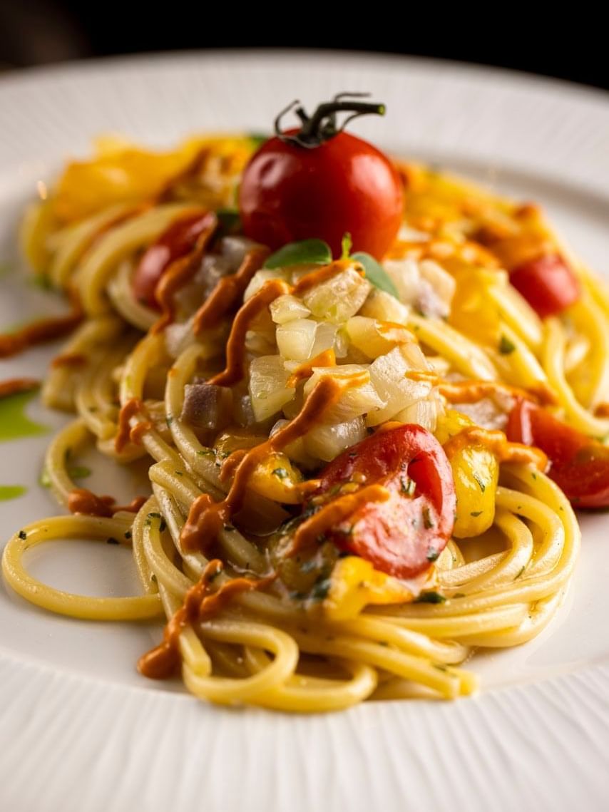 Close-up of creamy Spaghetti with roasted tomatoes served at Rome Luxury Suites
