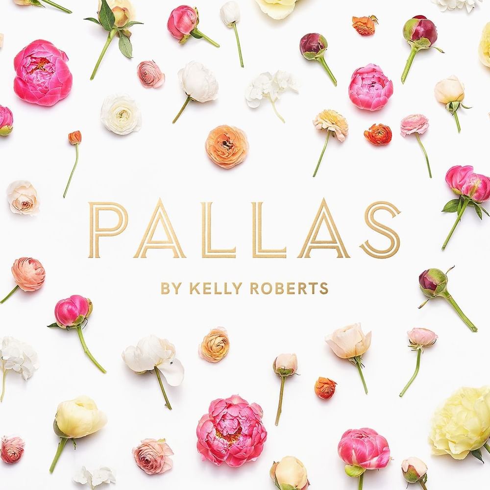 Web banner of Pallas by Kelly Roberts, gold logo centered on a white background with scattered roses used at Kelly's Spa
