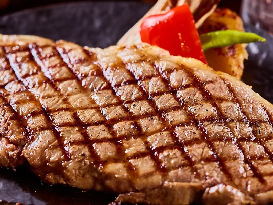 Grilled steak with grill marks, served with veggies at Park Hotel Group