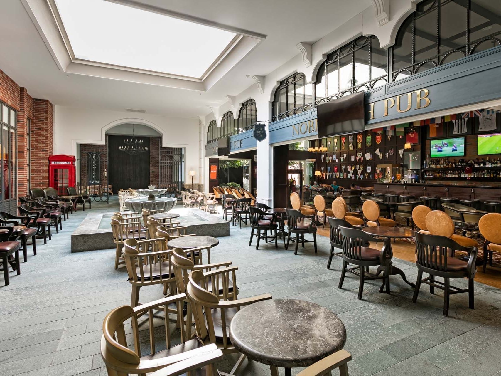 Dining area with multiple screens in Noble Irish Bar at Titanic Deluxe Golf Belek