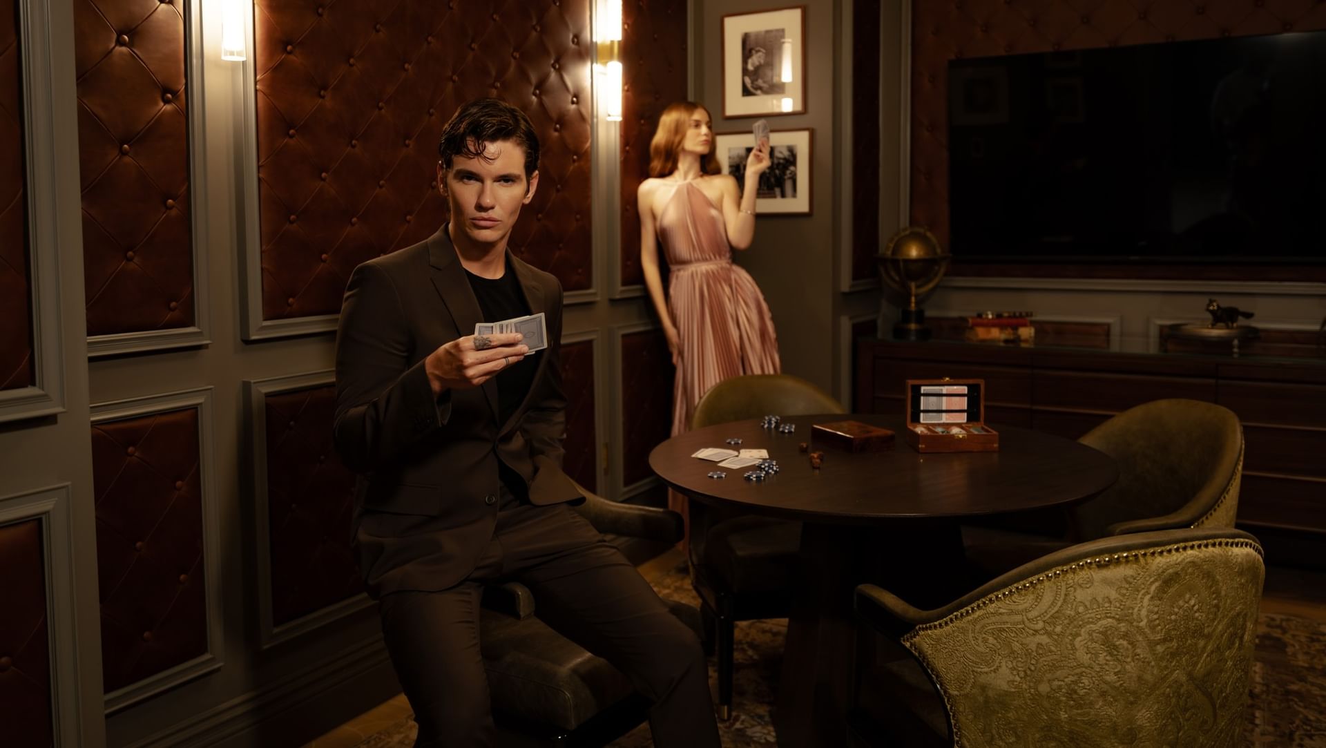 Man and woman playing cards in an elegant game room at 27 Wynwood